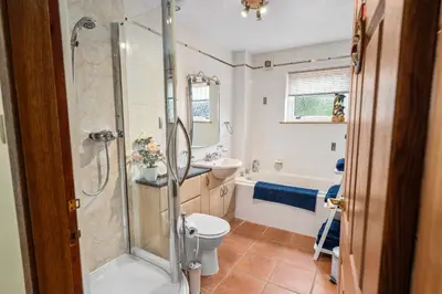 a bathroom with a shower and a toilet and a sink at Spacious 4BD Home with Stunning Oban Views in Oban
