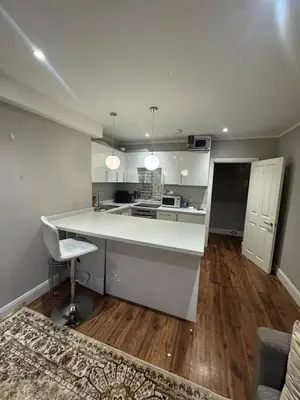a kitchen with a white counter top in a room at Amazing Flat in London in Moffat