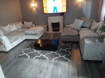 a living room with two couches and a tv at Newly renovated & furnished luxury bedroom in Kirkliston