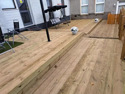 a wooden deck in front of a house at Newly renovated & furnished luxury bedroom in Kirkliston
