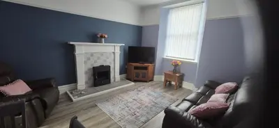 a living room with a couch and a fireplace at 46 High Street in Campbeltown