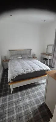 a bedroom with a bed and two side tables at 46 High Street in Campbeltown