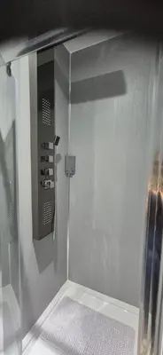 a bathroom with a shower with a glass door at 46 High Street in Campbeltown