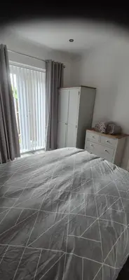a bedroom with a large bed and a window at 46 High Street in Campbeltown