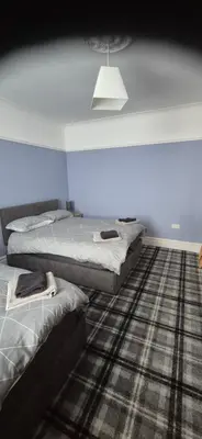 two beds in a room with blue walls at 46 High Street in Campbeltown