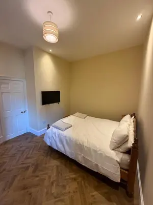 a bedroom with a bed and a flat screen tv at Entire rental in Edinburgh City Centre in Edinburgh