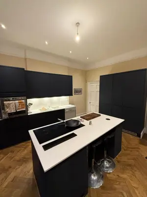 a kitchen with black cabinets and a white counter top at Entire rental in Edinburgh City Centre in Edinburgh