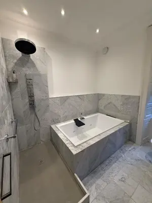 a bathroom with a large tub and a shower at Entire rental in Edinburgh City Centre in Edinburgh