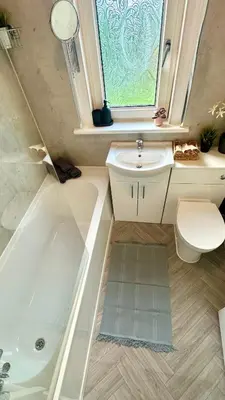 a bathroom with a sink and a tub and a toilet at New quite and comfy home Glasgow in Knightswood