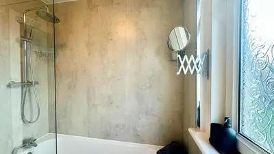 a bathroom with a shower and a bath tub at New quite and comfy home Glasgow in Knightswood
