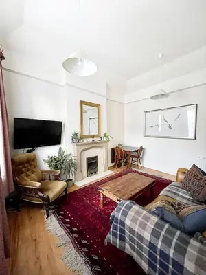 a living room with a couch and a fireplace at Little West End cottage in Edinburgh