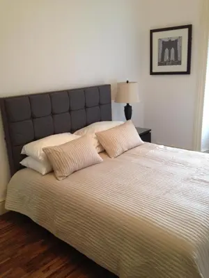 a bedroom with a large bed with two pillows at Caledonian Apartment in Edinburgh