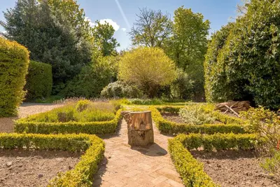 a garden with a tree stump in the middle at Blossom Mansion in Edinburgh