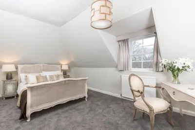 a bedroom with a bed and a desk and a chair at Blossom Mansion in Edinburgh