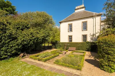 an old house with a garden in front of it at Blossom Mansion in Edinburgh