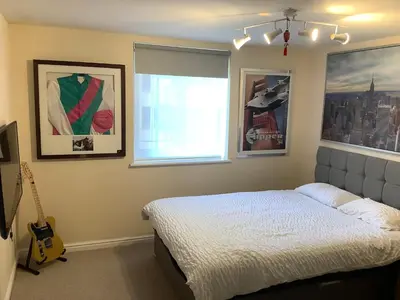a bedroom with a bed and a window and a guitar at 17 flat 11 slateford gait in Edinburgh