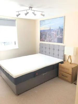 a large bed in a room with a large window at 17 flat 11 slateford gait in Edinburgh