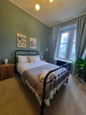 a bedroom with a bed and a window at Townhead Jewel by Coorie Doon Stays in Paisley