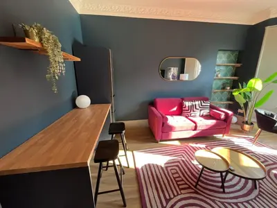 a living room with a pink couch and a rug at Townhead Jewel by Coorie Doon Stays in Paisley