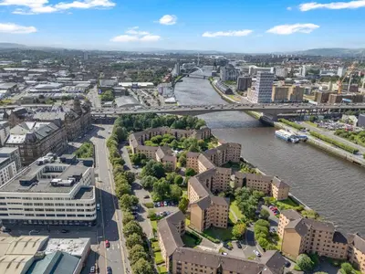 an aerial view of a city with a river and buildings at Riverside City Apartment in Glasgow