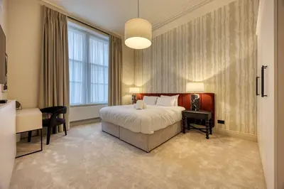 a hotel room with a bed and a desk at Luxury Refurbished City Retreat in Glasgow