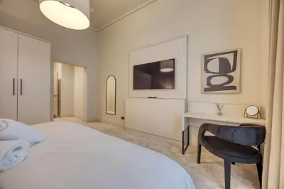a bedroom with a bed and a desk and a chair at Luxury Refurbished City Retreat in Glasgow
