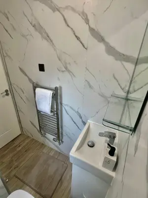 a white bathroom with a sink and a toilet at Newly refurbed 3 bed home 15mins to Edin city in Livingston