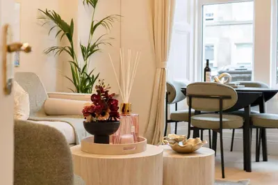 a living room with a couch and a table at The Compact Caledonian Flat - Haymarket in Edinburgh