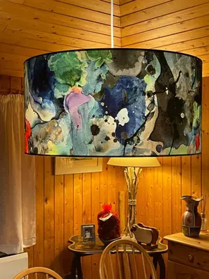 a painting hanging above a table in a room at Grey Gables Cottage, Brodick, Isle of Arran, Scotland in Isle of Arran