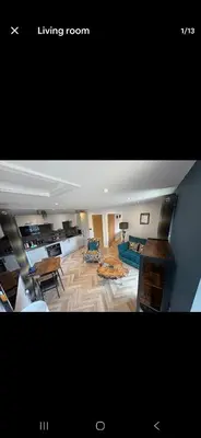 a living room with a couch and a table at The Wee Bothy in Oban