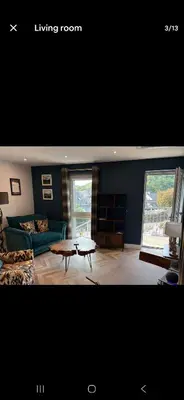 a living room with a couch and a table at The Wee Bothy in Oban