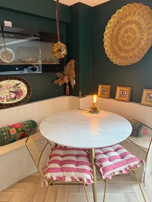 a table and chairs in a room with green walls at The Rookery in Moffat