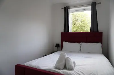 a bedroom with a bed with white towels on it at Glasgow Group Getaway in Glasgow