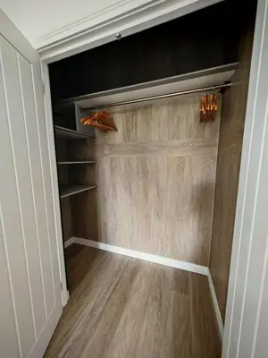 a walk in closet with wood flooring at Cozy corner 2 bedroom house in Edinburgh