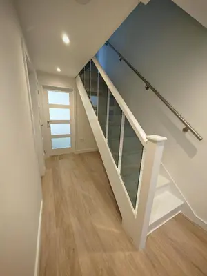 a staircase in a house with glass shelves at Cozy corner 2 bedroom house in Edinburgh