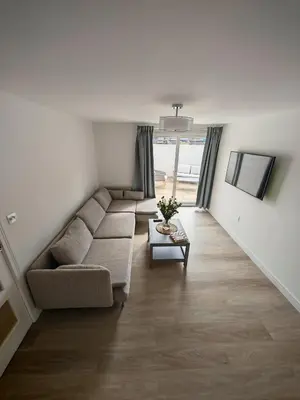 a living room with a couch and a table at Cozy corner 2 bedroom house in Edinburgh