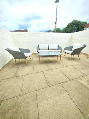 two chairs and a couch in front of a wall at Cozy corner 2 bedroom house in Edinburgh