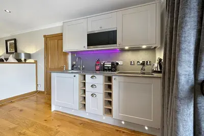 a kitchen with white cabinets and a counter top at The Allanbreck Studio Glencoe Ballachulish Highlands Near Fortwilliam in Glencoe