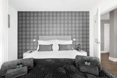 a bedroom with a large white bed with two pillows at Castle Street Apartments - Luxury Kerrycroy Ground Floor Apartment in Rothesay