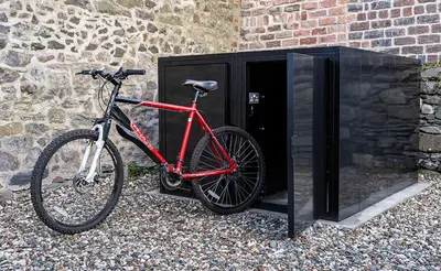 a red bike parked next to a building at Castle Street Apartments - Luxury Kerrycroy Ground Floor Apartment in Rothesay