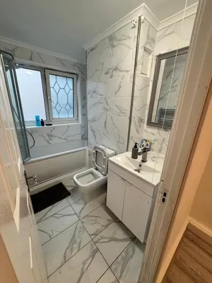 a white bathroom with a sink and a toilet at Modern 3-Bed Flat Stylish Family-Friendly in Moffat