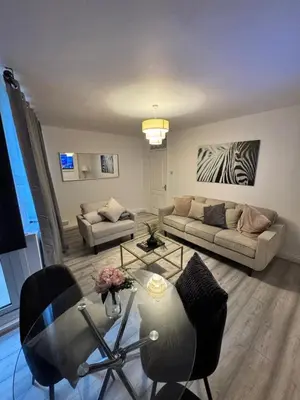 a living room with a couch and a table at Modern 3-Bed Flat Stylish Family-Friendly in Moffat