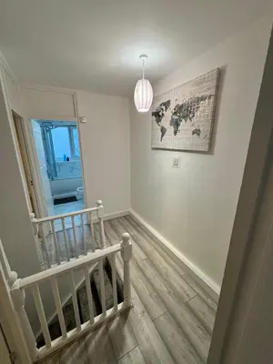 a room with a staircase and a map on the wall at Modern 3-Bed Flat Stylish Family-Friendly in Moffat