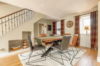 a dining room with a table and chairs at Kilmore Paws and Relax in Comrie