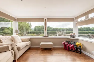 a living room with a couch and a window at Kilmore Paws and Relax in Comrie