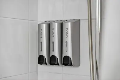 a group of silver devices on a wall at Modern 2-Bedroom flat in Glasgow city centre, near Galsgow Green in Glasgow