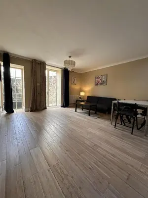 an empty living room with a table and a couch at Walker Apartment in Edinburgh