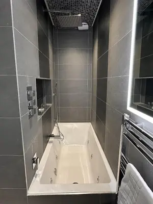a large bath tub in a bathroom with at Walker Apartment in Edinburgh