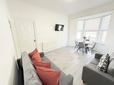 a living room with a couch and a table at 2Bed Gla Green, Walk Dist City Centre in Glasgow