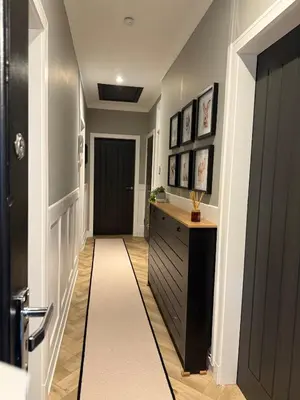 a hallway with a black door and a white rug at Luxury Old Town Apartment just a 5 Minute Walk to Stirling Castle in Stirling